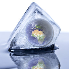 Frozen earth globe inside the ice cube