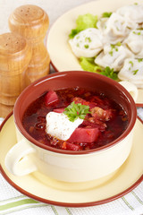 Russian cuisine. Borscht and pelmeni on the served table