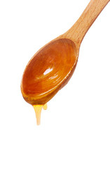 wooden spoon with honey isolated