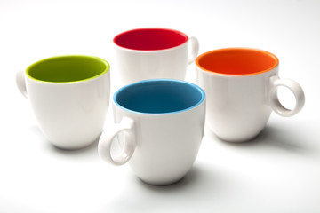 four cups on white background