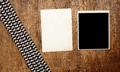 Old photo frames on vintage wood background with rope