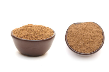 ground nutmeg in a clay bowl