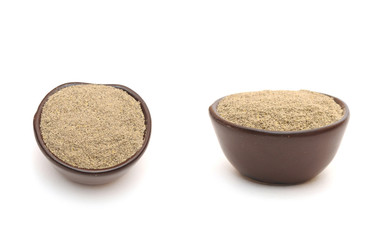 black pepper  in a clay bowl
