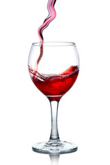 Red wine pouring in glass isolated on white