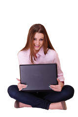 A woman sits with a laptop in the hands of
