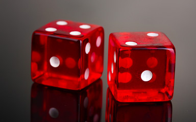Red dices on grey background