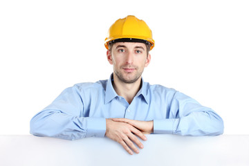Young man architect with helmet isolated on white