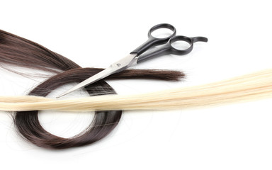 Shiny blond and brown hair with hair cutting shears isolated