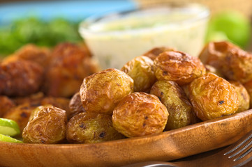 Baked potatoes with fried breaded calamary and tzatziki