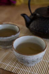 Fototapeta na wymiar Green tea in a ceramic teacups