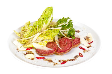 Salad from fried sausages, lettuce with sour cream sauce