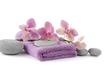 Pink spa towels and beautiful orchid with pebble