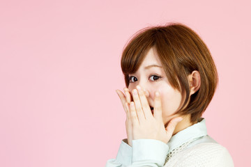 Beautiful young woman on pink background
