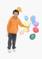 Happy little boy with colorful balloons