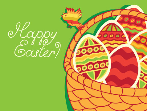 basket of Easter eggs on green background