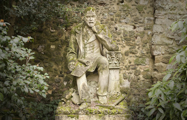Fototapeta na wymiar old weathered statue of a poet