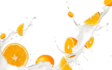 Oranges pieces falling in milk splash,isolated on white