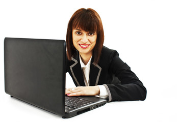 Smiling beautiful young business woman working on laptop
