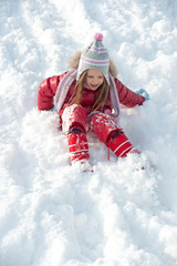 Young girl playing on the snow.