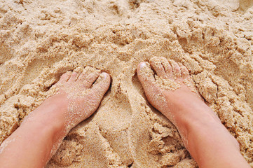 Feet in the sand on the beach