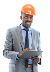 Confident ethnic architect wearing a hardhat against