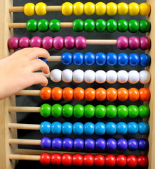 Colorful abacus and child hand