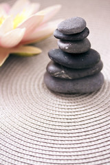 Fototapeta na wymiar pile of stone and lotus flower: zen, balance and meditation