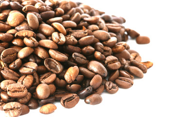 Whole coffee beans scattered on white background