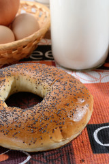 Bun on the tablecloth next to the milk