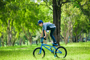 Your boy performing trick on bicycle outdoors