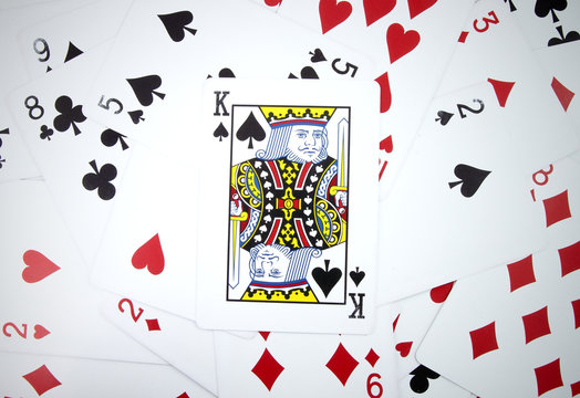 King card with playing cards background