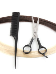 Shiny blond and brown hair with hair cutting shears and comb