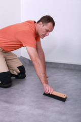 man laying linoleum