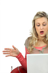 Naklejka premium Girl with expression of surprise using laptop computer