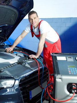 Motor mechanic is checking the air handling unit of a car