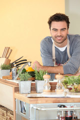 Smiling chap relaxed in his kitchen