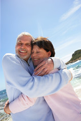 Senior couple hugging at the seaside