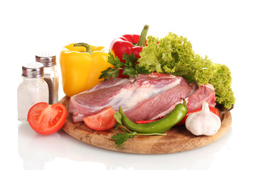 Raw meat and vegetables on a wooden board isolated on whitе