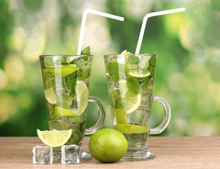 Glasses of cocktail with lime and mint