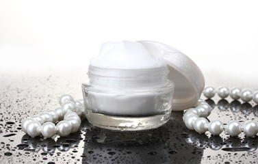 Fototapeta na wymiar cosmetic cream on table isolated on white