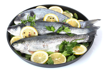 Fresh fishes with lemon, parsley and pepper