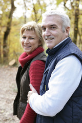 Fototapeta premium Couple walking through woods