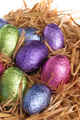 Straw nest with chocolate Easter eggs