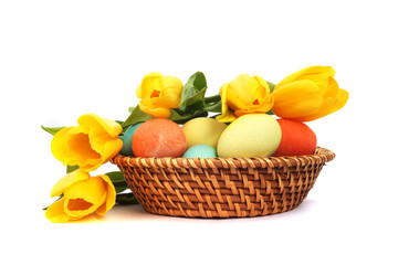 Easter eggs in basket with tulips