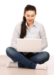 A woman with a laptop sitting on the floor