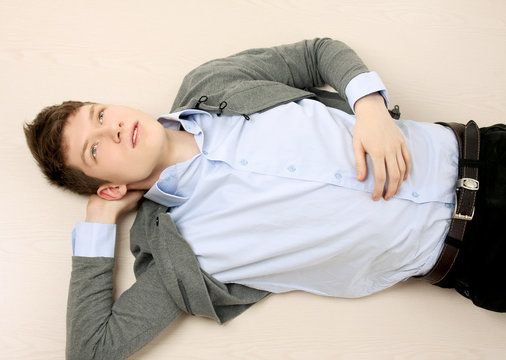 A handsome guy lying on the floor, top view