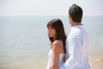 Young couple wearing white at the beach