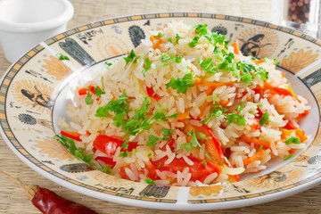 Vegetable risotto made of carrot, red bell pepper, parsley