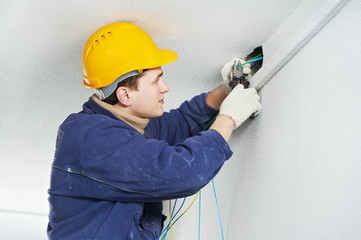 Electrician at cable wiring work