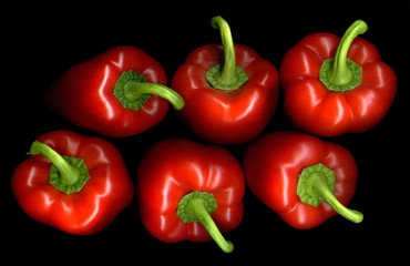 Six red pepper on a black background
